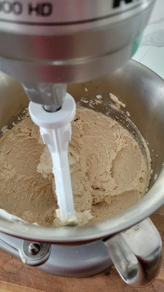 A process shot of the shortening and sugars being creamed together in a stand mixer for old fashioned molasses cookies
