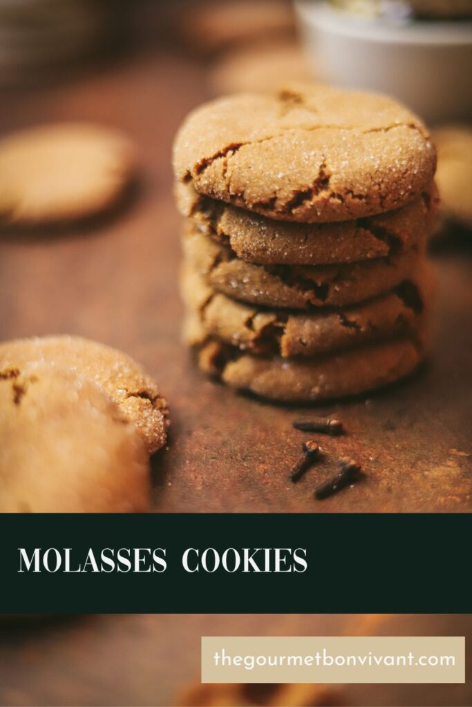 Stack of molasses cookies with cloves and title text.