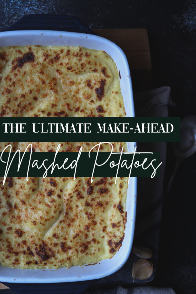 A photo of the ultimate make-ahead mashed potatoes in a large casserole dish, golden cheese on top