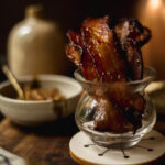 Photo of maple mustard candied bacon in a glass