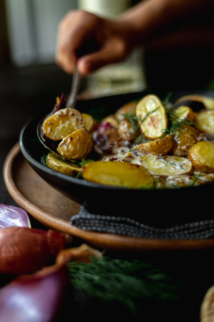 A bowl of easy roasted potato salad with dill and white wine