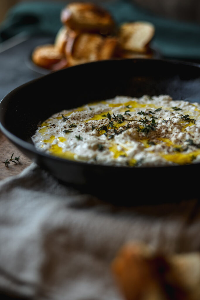 A photo of ricotta cheese with oregano and olive oil