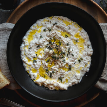 A photo of ricotta cheese with oregano and olive oil