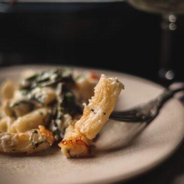 A photo of bechamel pasta on a fork