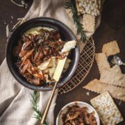 A photo of baked brie with caramelized onions, rosemary and balsamic vinegar