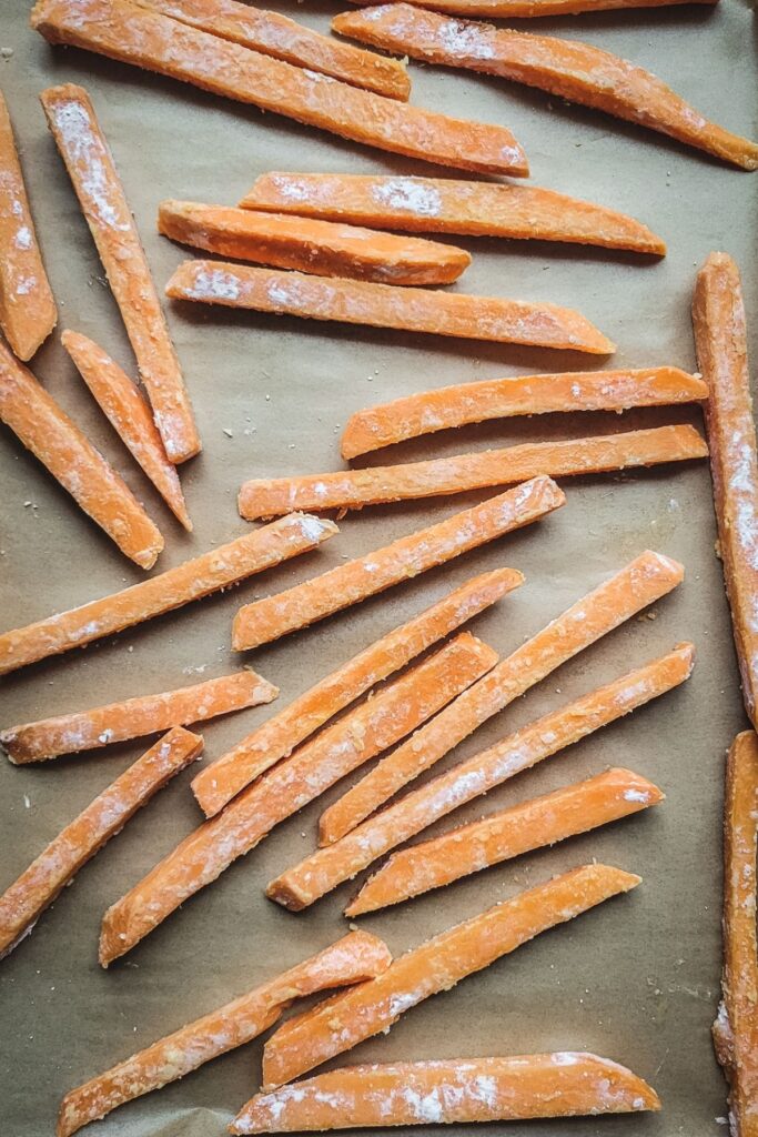 sweet potato fries on a baking sheet - raw