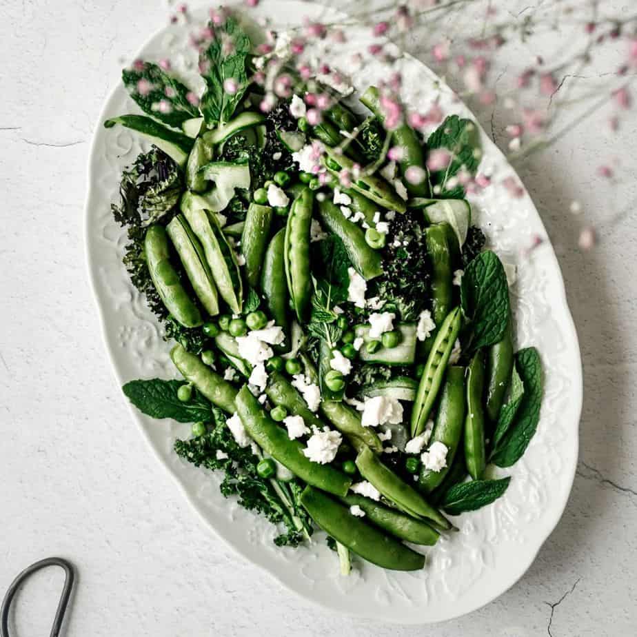 asparagus and pea salad on a white platter