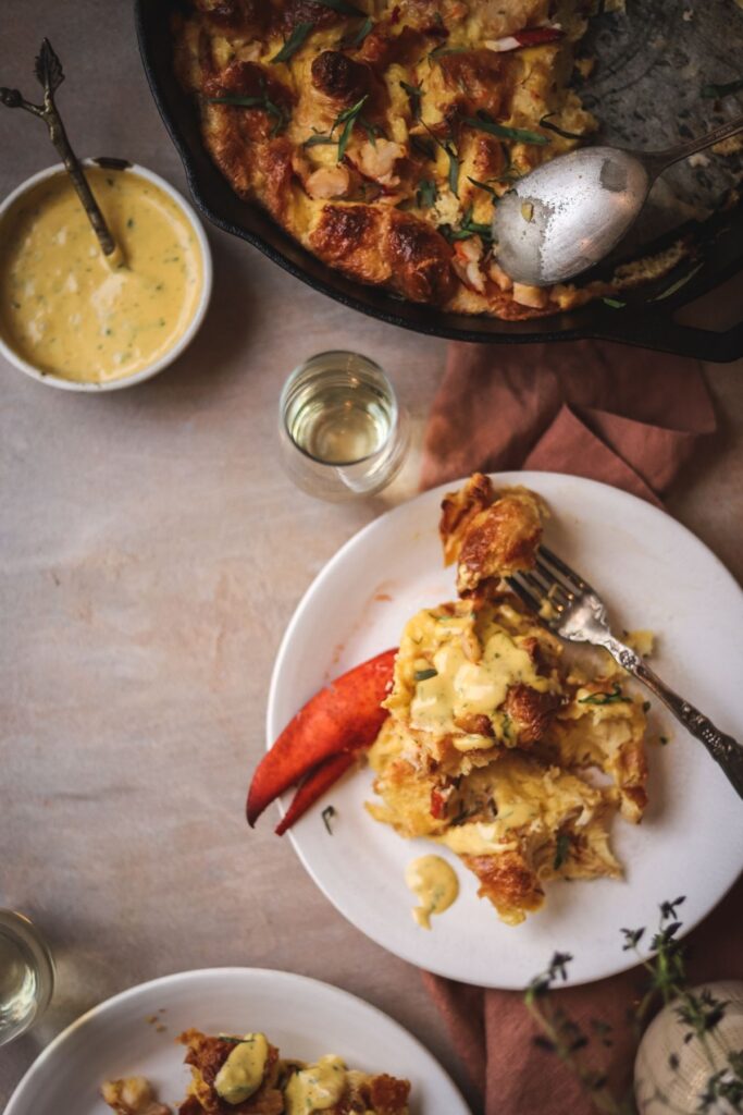 a shot of eggs benedict bake with lobster and tarragon hollandaise