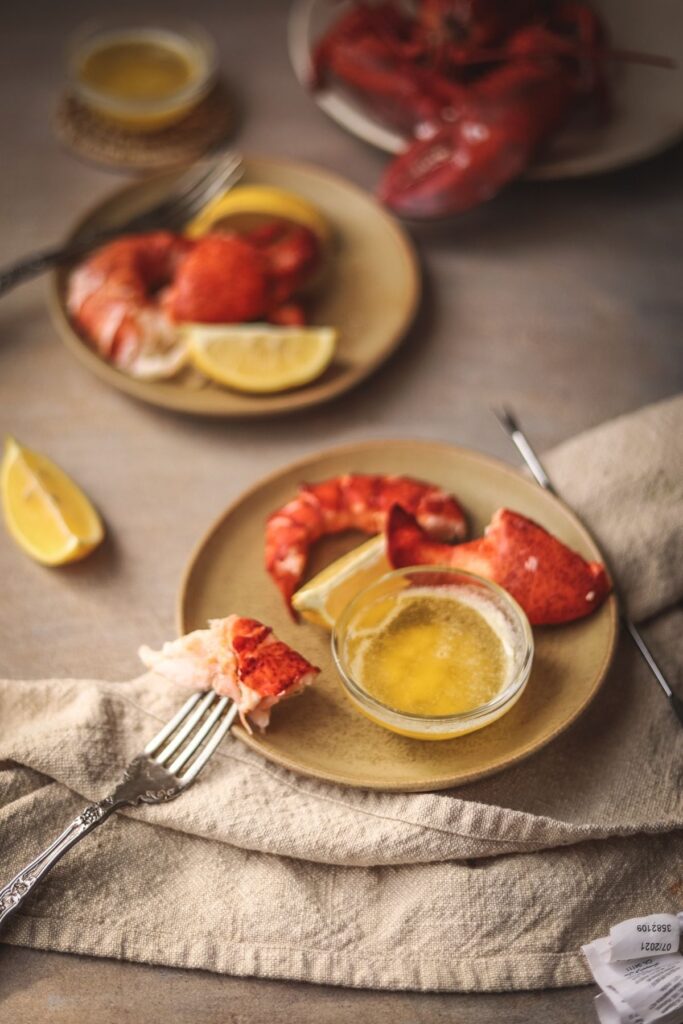 A photo of cooked lobster with lemon and butter