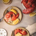 how to cook lobster: A photo of cooked lobster meat with lemon and butter