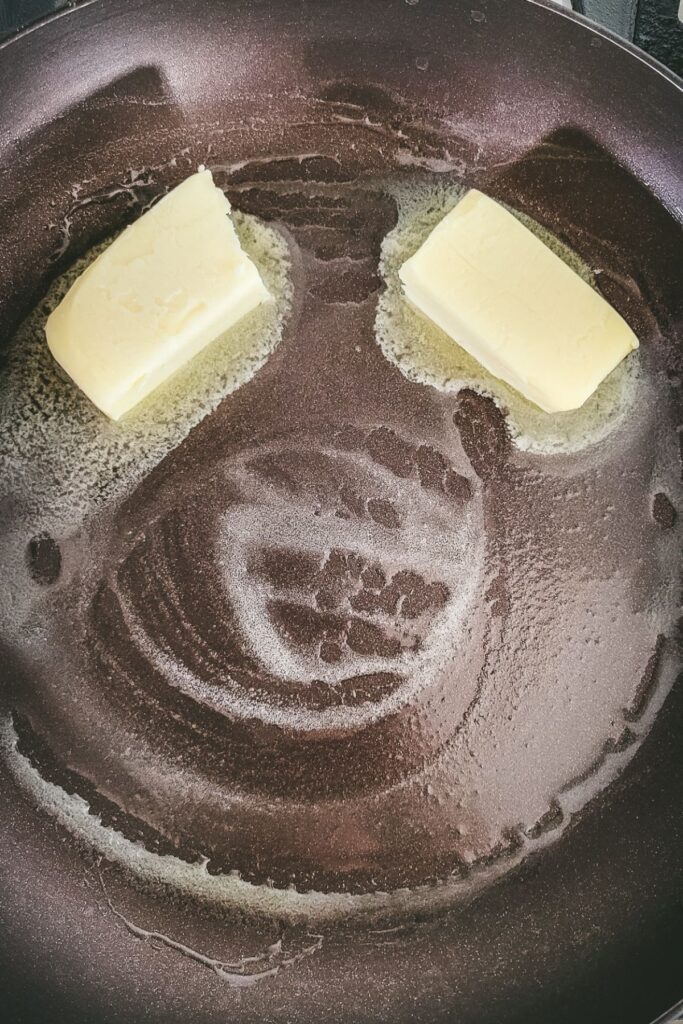 butter melting in a frying pan