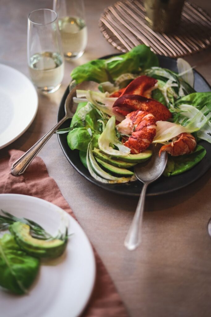 A photo of lobster avocado salad with champagne