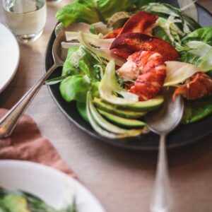 A photo of lobster avocado salad with champagne