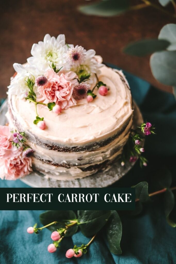 A photo of old-fashioned carrot cake decorated with spring flowers with title text.