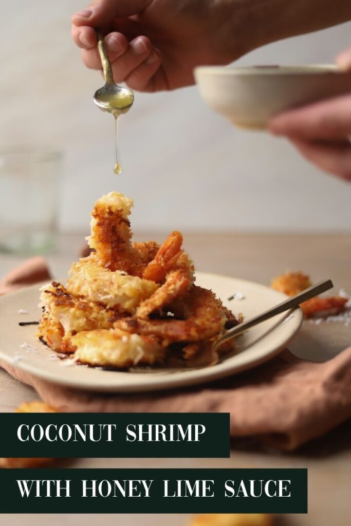 Sauce being poured over coconut shrimp
