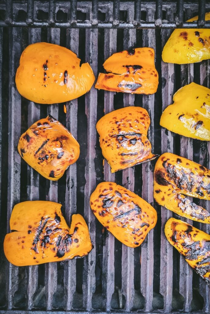 Peppers that have been grilled on one side on the bbq.