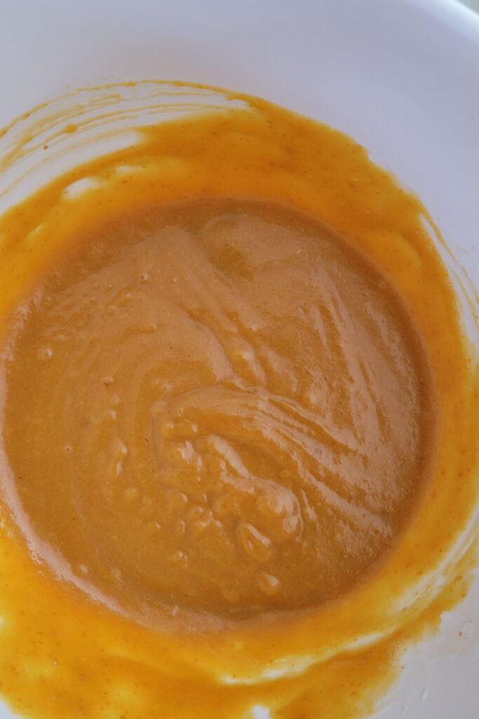 A photo of the wet ingredients mixed for pumpkin bread. 