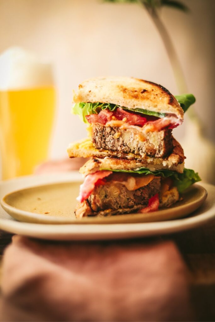 Two halves of a meatloaf sandwich stacked on top of each other. 