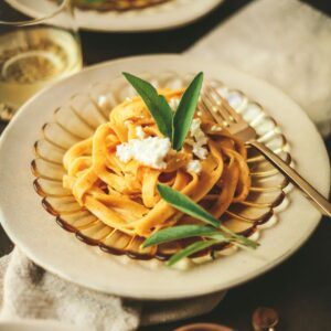 close up of pumpkin pasta with sage and goat cheese.