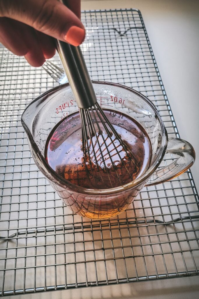 A whisk inside the measuring cup. 