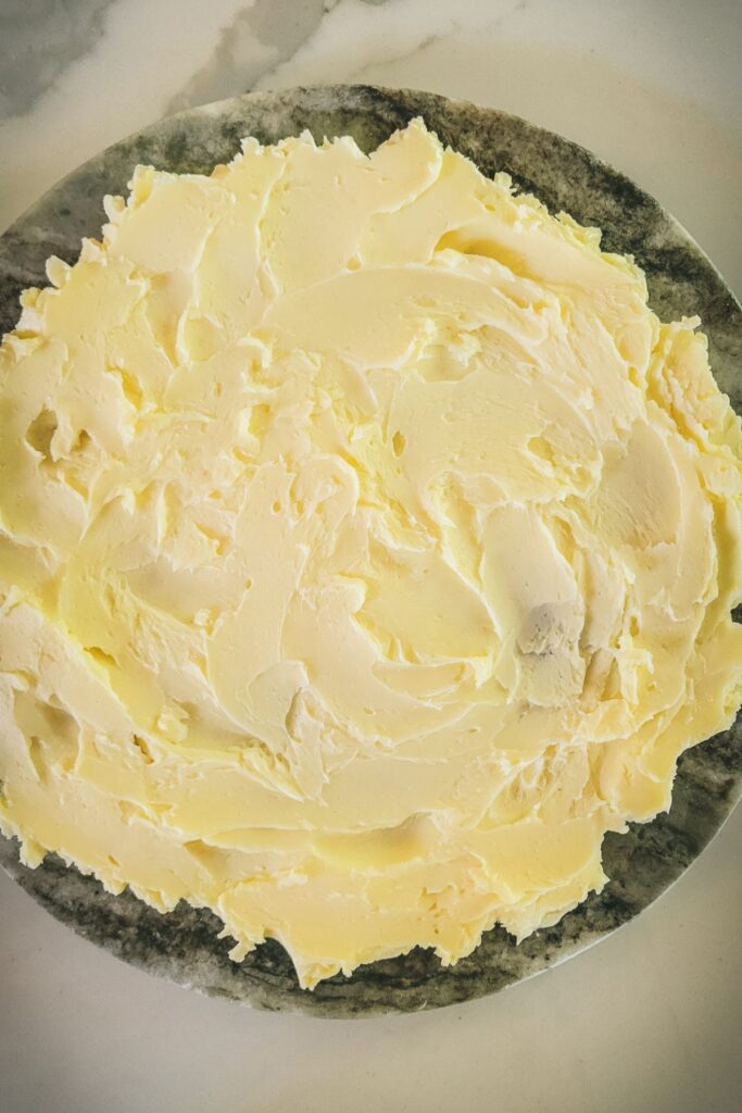 Butter spread out on a marble slab.