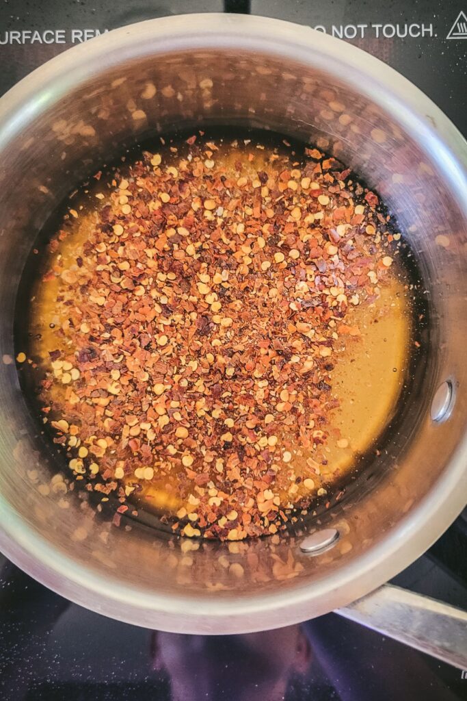 Honey and hot pepper flakes in a pot.
