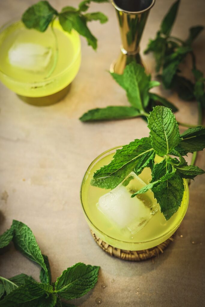 Two cocktails with limoncello and mint. 