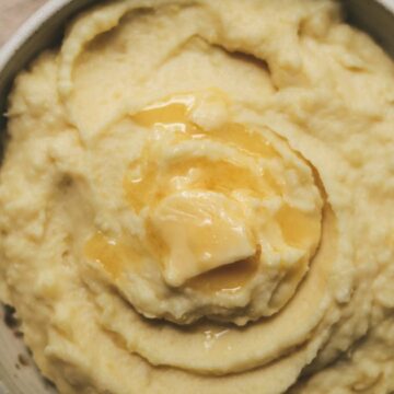 Close up overheat shot of truffle mashed potatoes with melted butter on top.