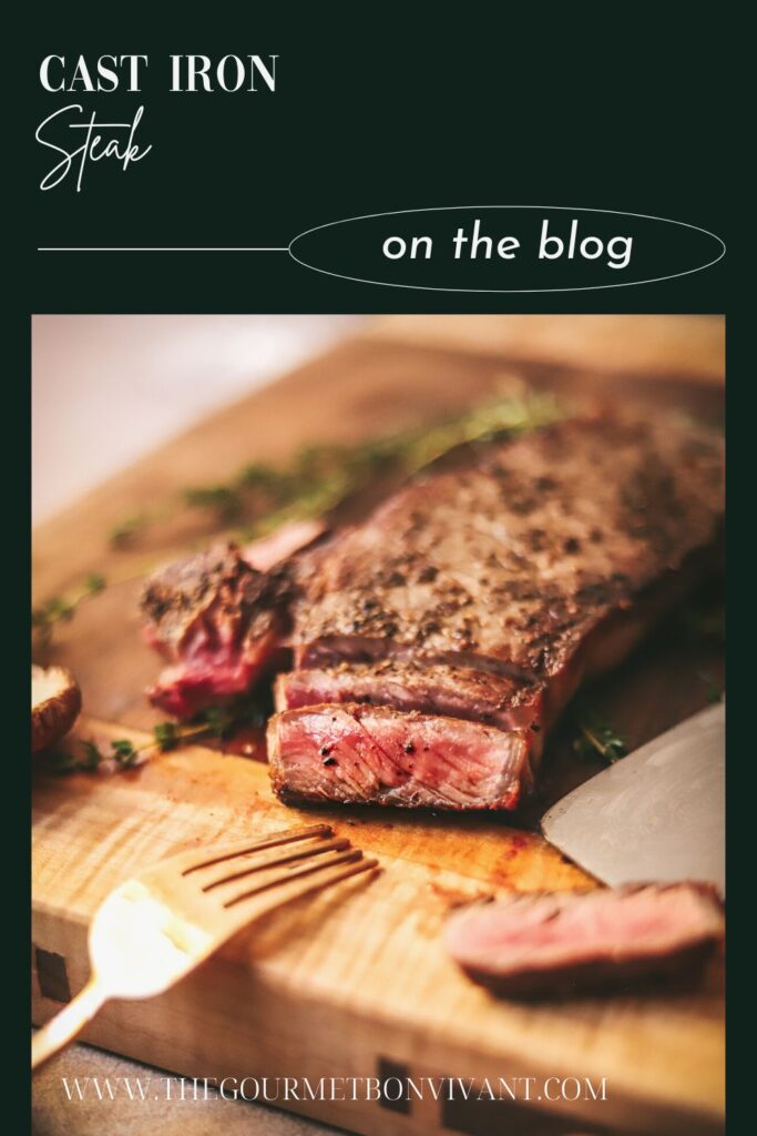 Steak on a cutting board, sliced, dark green background.
