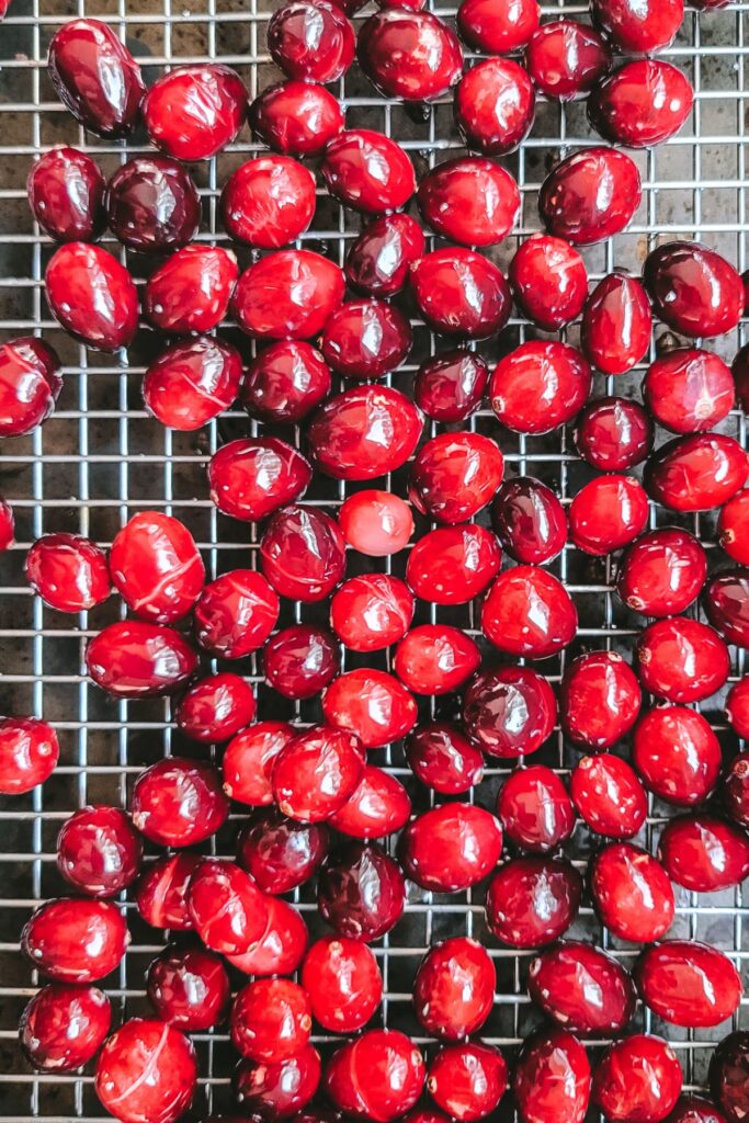 Cranberries drying on a cooling rack.