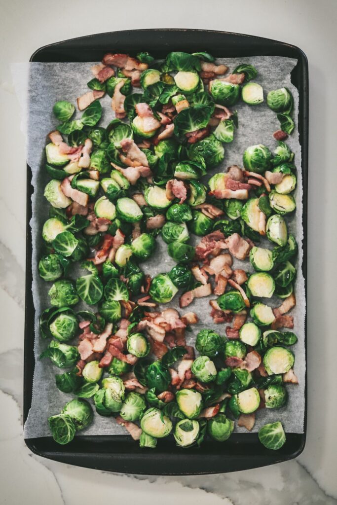 Brussel's sprouts and bacon on a baking sheet. 