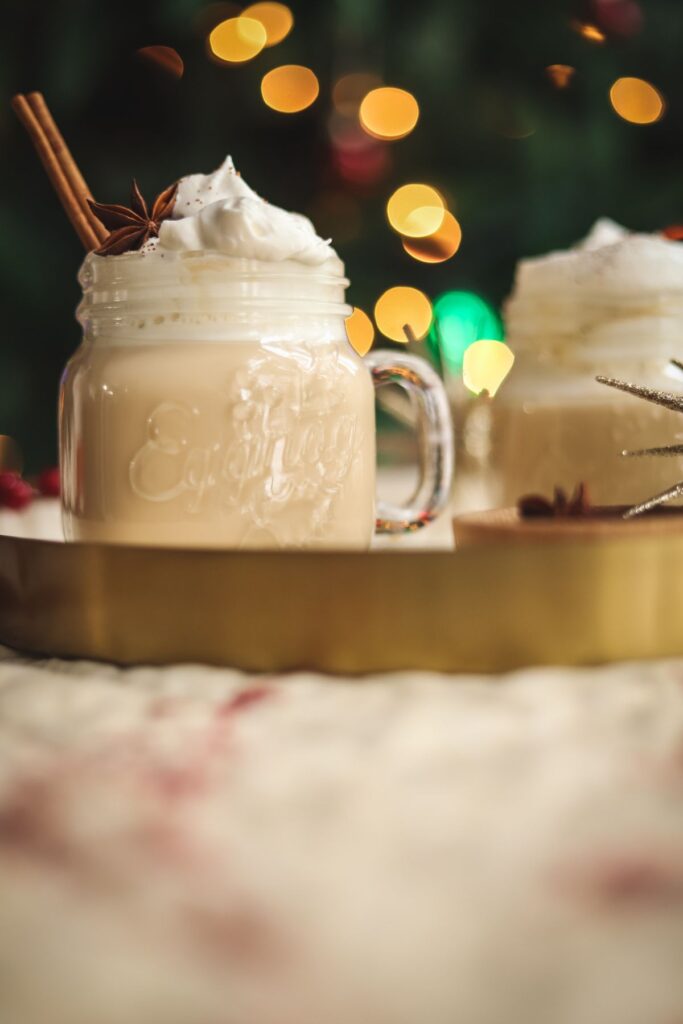 Eggnog latte on a tray in front of a Christmas Tree.