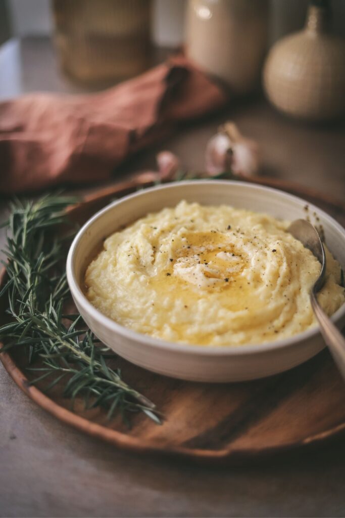 A bowl of instant pot mashed potatoes with melted butter. 