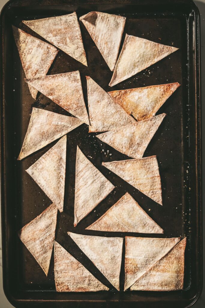 Wonton chips on a baking sheet.