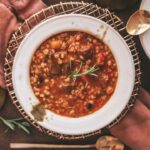 Beef barley soup with red wine and napkins.