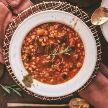 Beef barley soup with red wine and napkins.