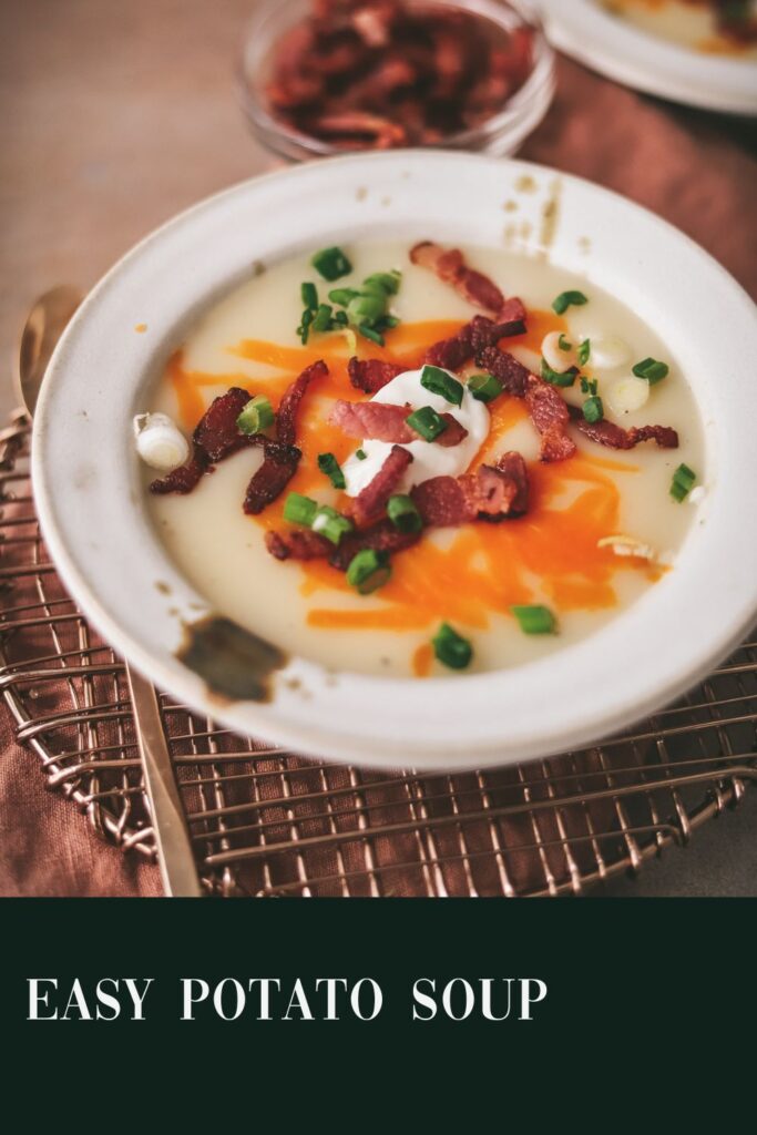 A bowl of potato soup with garnishes, on a trivet. Title text included.