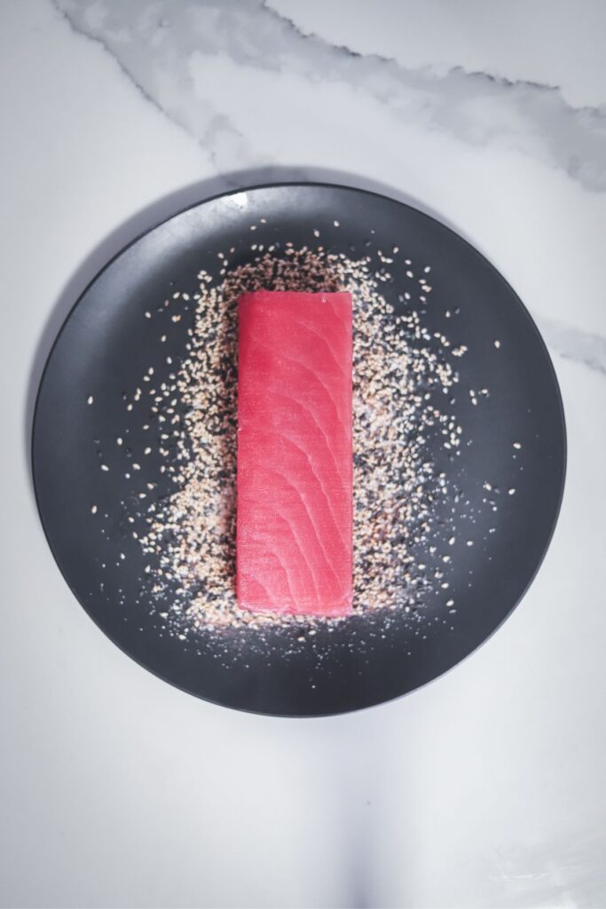 A tuna steak pressed into sesame seeds. 