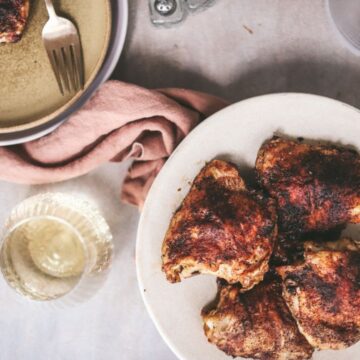 A plateful of baked chicken thighs.