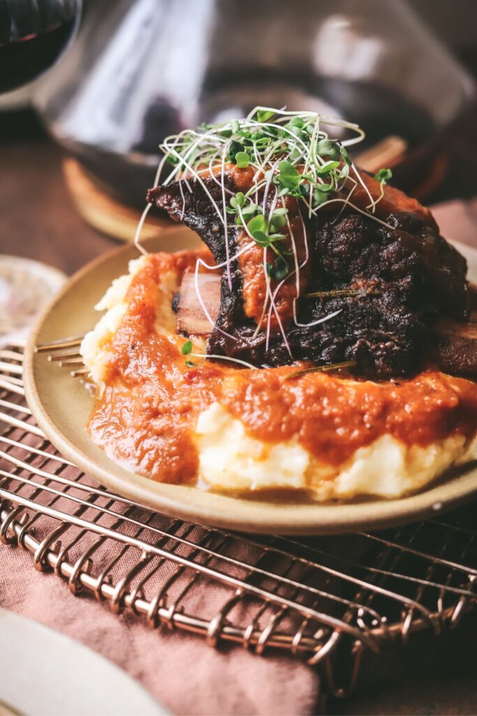 Braised beef short ribs with sauce and mashed potatoes. 