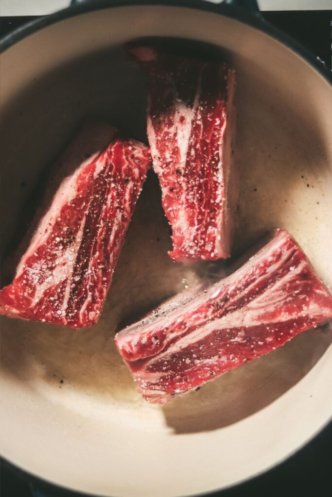 Short ribs in a Dutch oven, just starting to cook. 