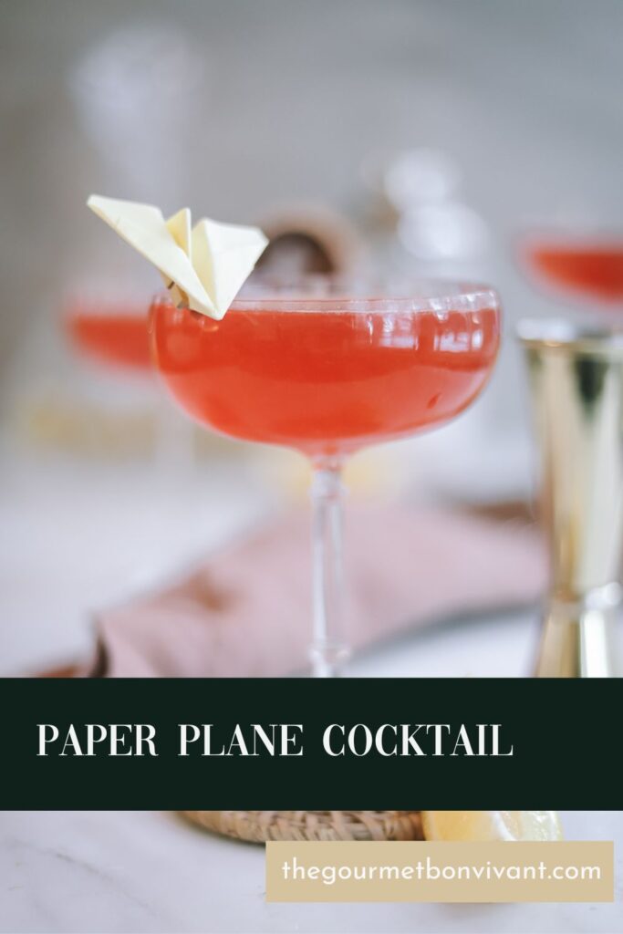 A paper plane cocktail with title text.