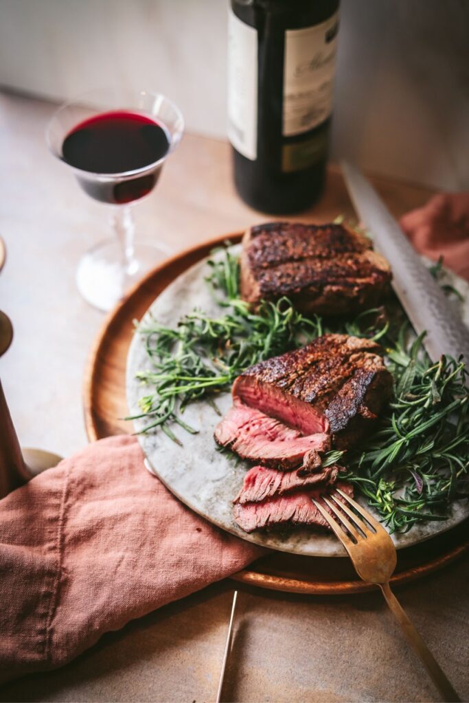 A sliced filet mignon with red wine and herbs. 