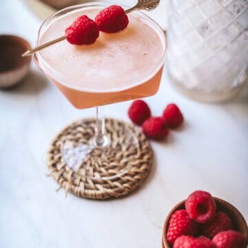 A french martini garnished with fresh raspberries.