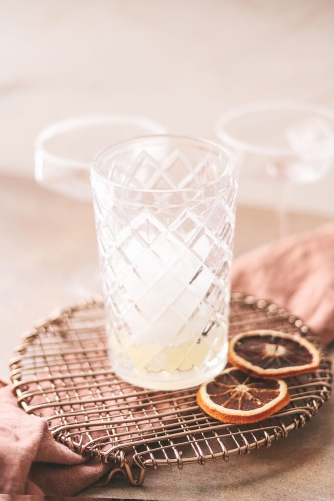 Lemon juice and orange liqueur in cocktail shaker. 