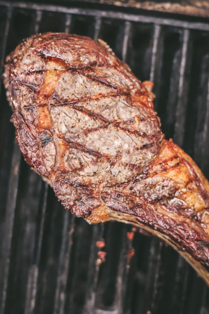 Tomahawk on the grill flipped with diamond grill marks. 