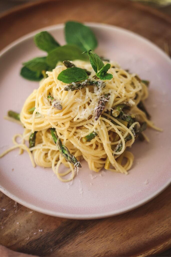A plate of asparagus pasta with mint and parmesan. 