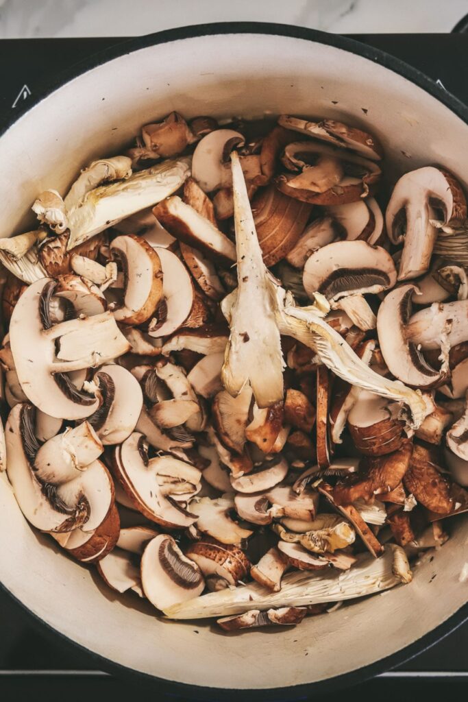 Mixed mushrooms cooking in a bot. 