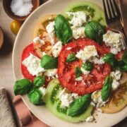 Caprese salad with basil and mozzarella on a plate.