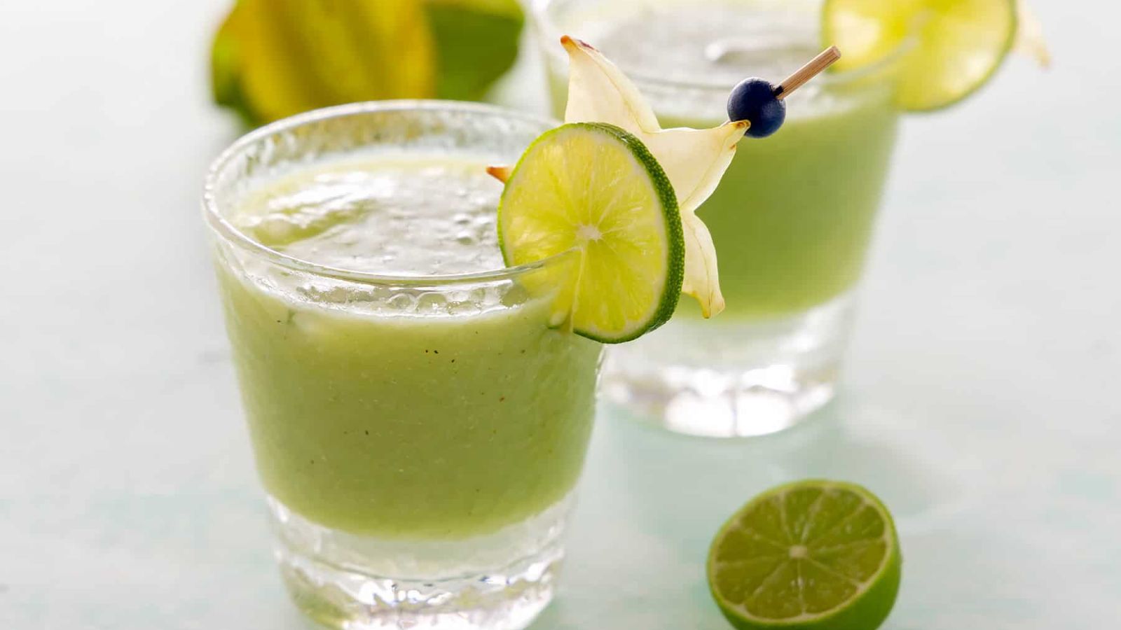 A glass of cucumber juice with lime. 